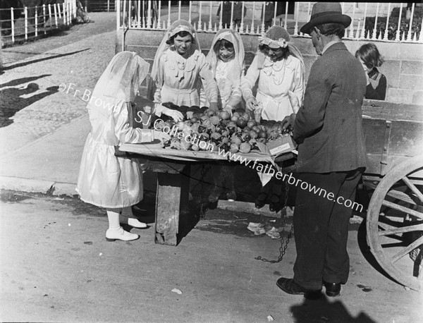 VEILED GIRLS AT ROADSIDE STALL